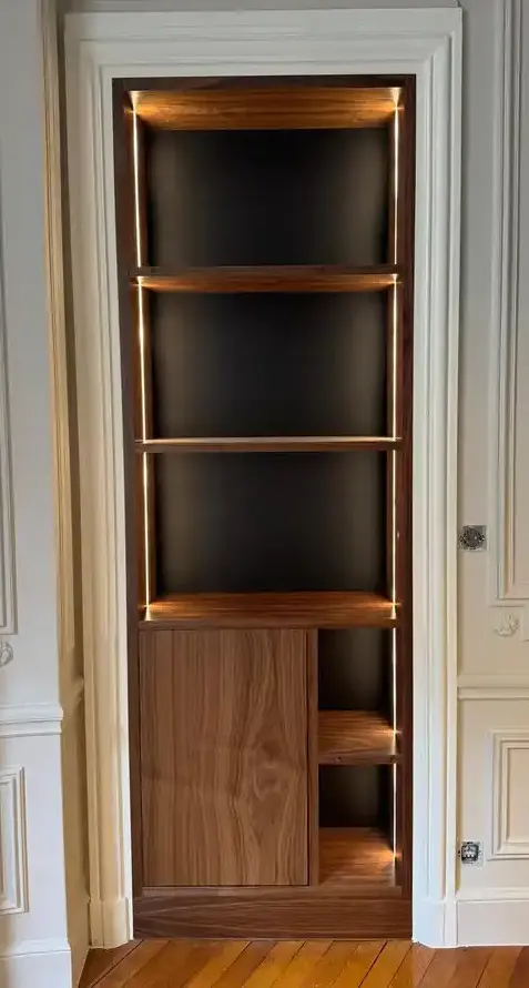 Built-in walnut display unit with LED edge lighting, glass shelving, and lower cabinet storage in classical interior